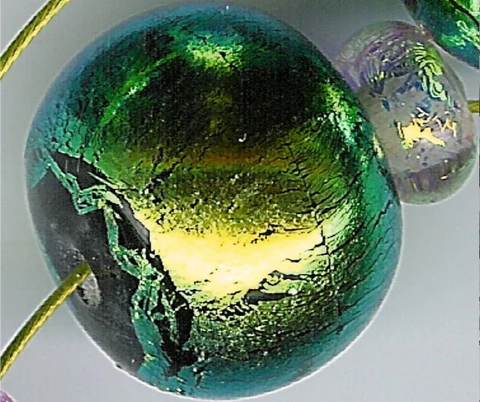 Glass bead showing surface coating wear