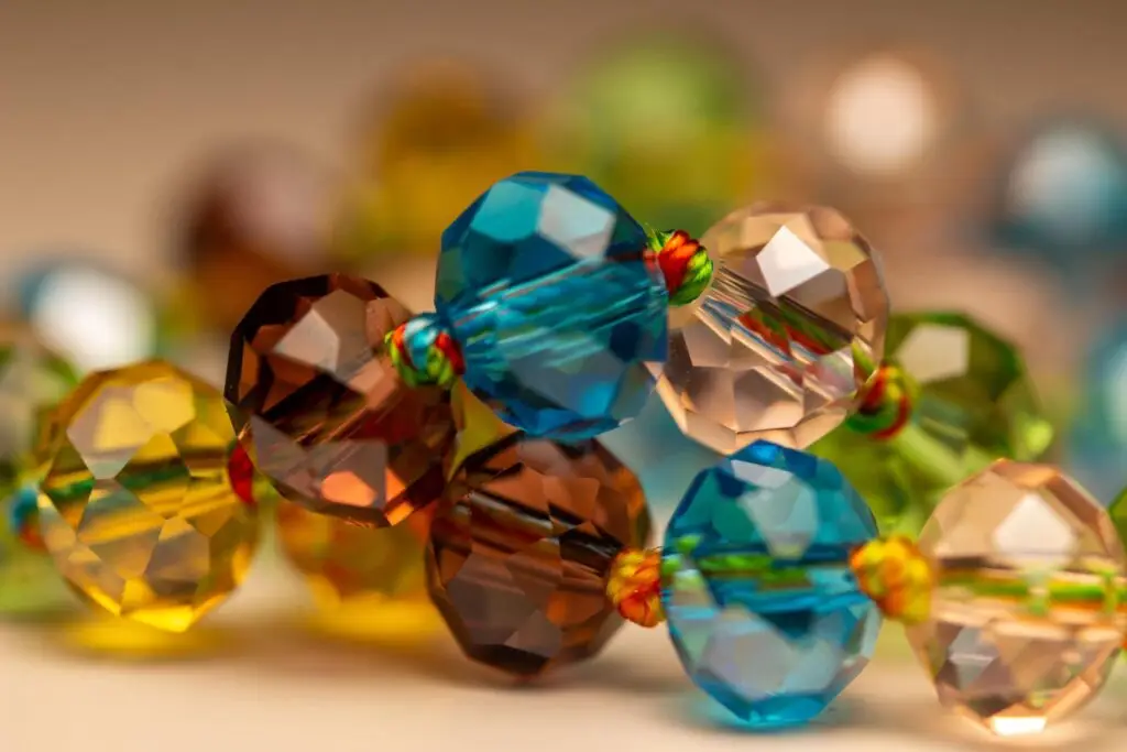 Faceted glass beads reflecting light in jewelry